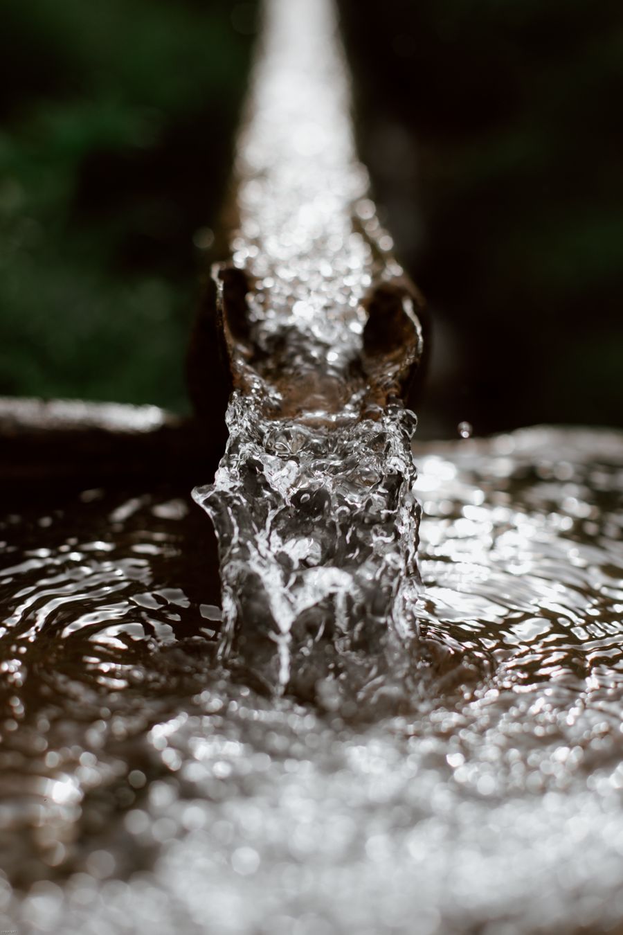 Clear well water flowing from a pipe after a submersible pump repair