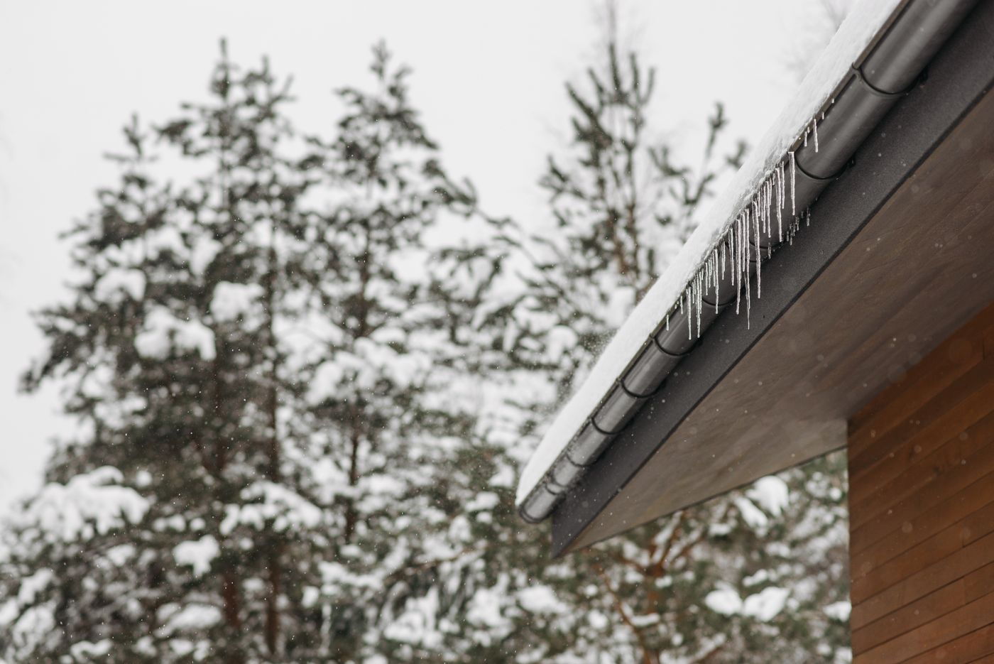 Icicles on a roof edge during a winter freeze that can damage jet pumps